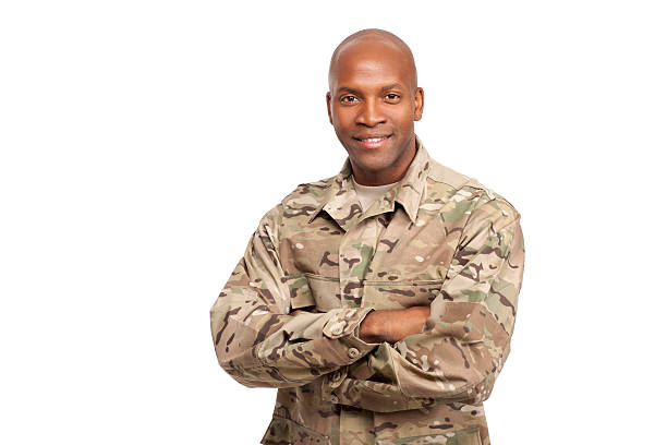 Portrait of happy American African soldier with arms crossed An african american soldier smiling in camouflage clothing  black military man stock pictures, royalty-free photos & images