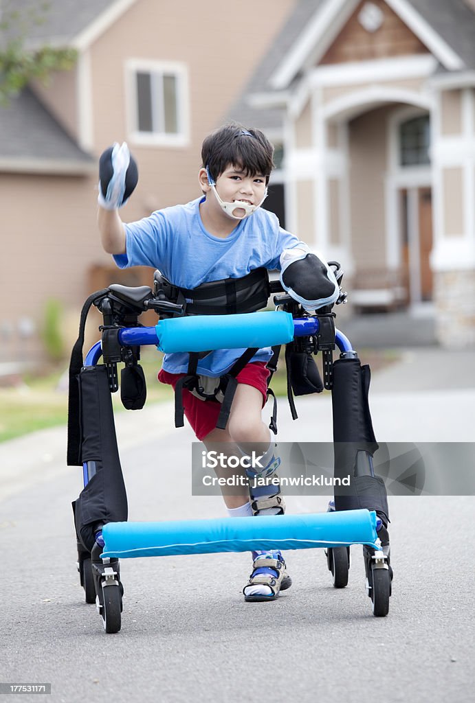 Seis años viejo niño corriendo en walker para personas con discapacidades - Foto de stock de Parálisis cerebral libre de derechos