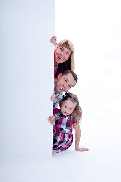 istock Family peek out surprised and smiling 177531517