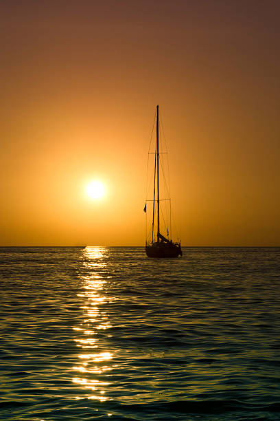 sailboat and sea sunset stock photo