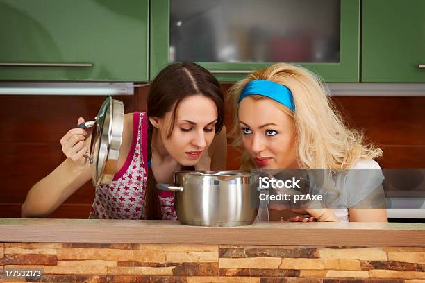 Two Young Women With A Pot Of Soup Stock Photo - Download Image Now - Bizarre, Food, Smelling