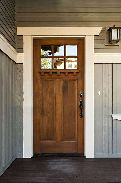 istock Dark wooden front door from inside a home 177532218
