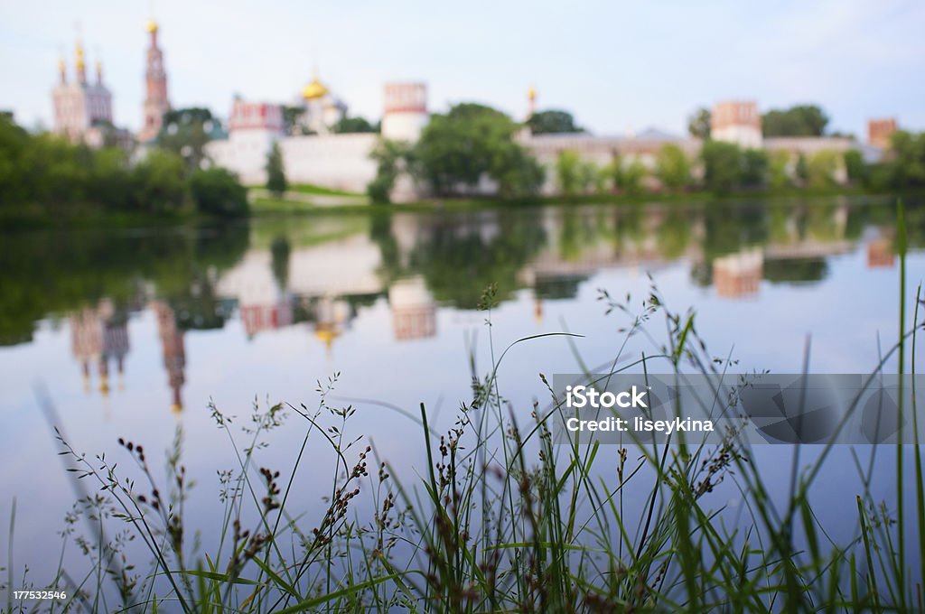Moscow monastery at sunrise. Early morning view Moscow Novodevichiy monastery in Russia. Focus on a grass. Architecture Stock Photo