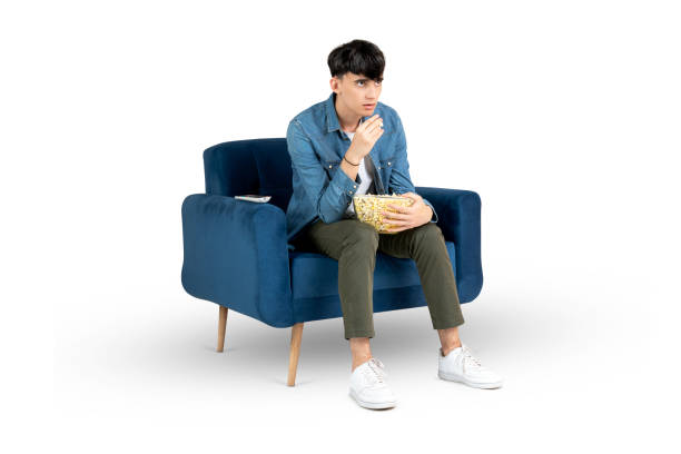 istock Teenager watching a movie eating popcorn 1775328310