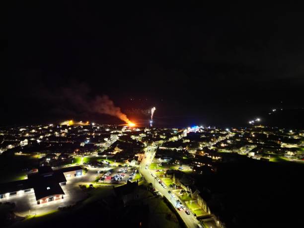 Fireworks Over Rosehearty Fireworks over the coastal town of Rosehearty in Aberdeenshire, Scotland. beach fire scotland stock pictures, royalty-free photos & images