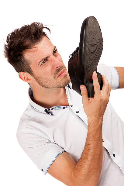 istock Man holding one shoes close to his nose 177533025