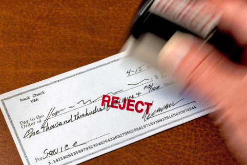 A stamp is used to mark a personal check reject