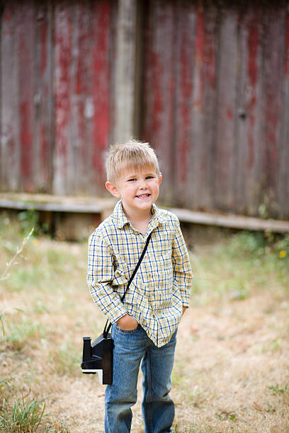 Small boy holding Polaroid camera stock photo
