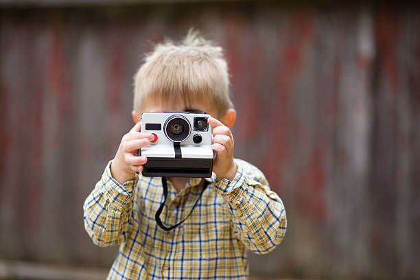 Portrait of child with Polaroid stock photo