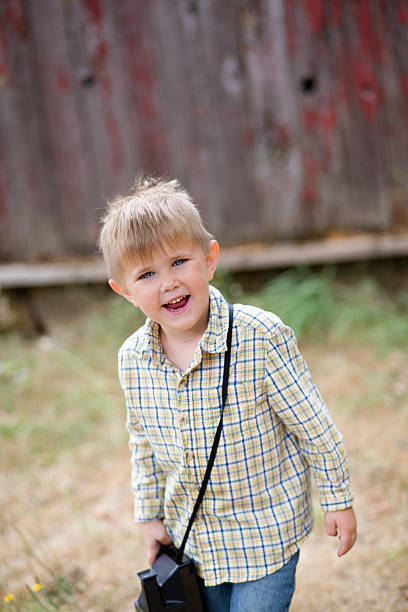 Child with Polaroid camera stock photo