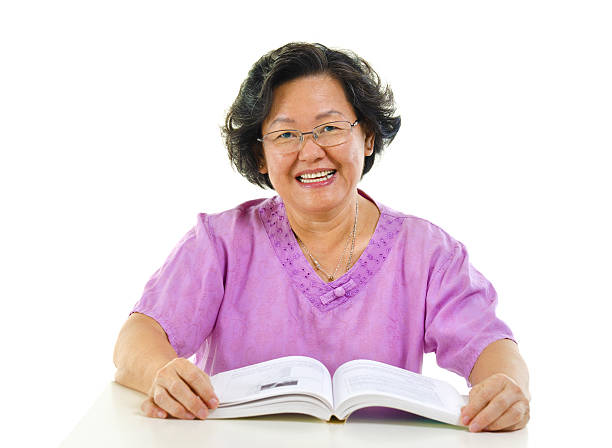 istock Asian senior woman reading book over white background 177534444