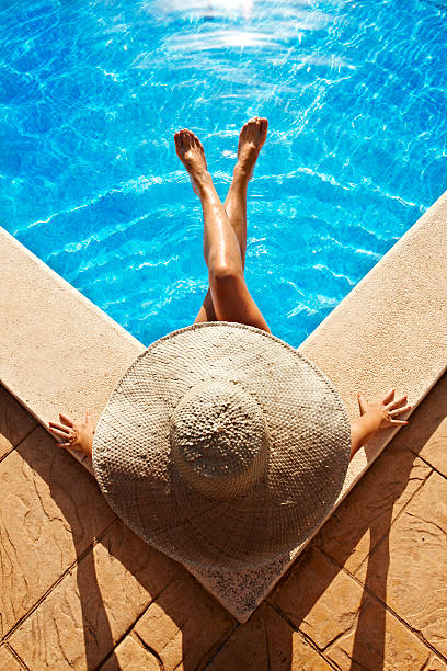 istock Woman sitting at poolside 177536425