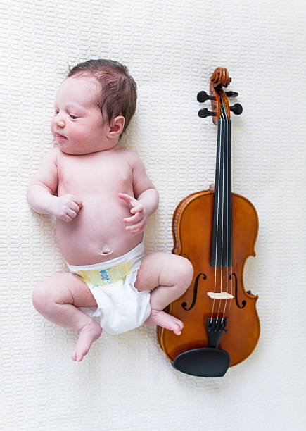 istock Baby girl next to violin 177536625
