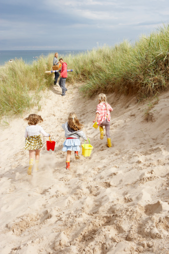 Family having fun on beach vacation Children Running