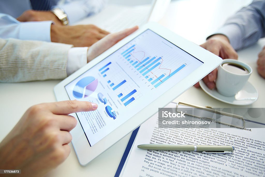 Market analysis charts and graphs being observed  Business people hands during discussion of the situation on the market Analyzing Stock Photo