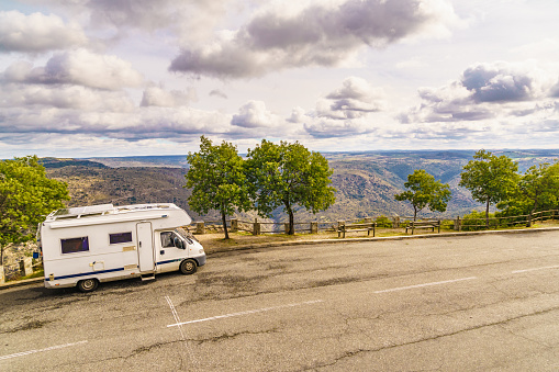 Caravan camping in mountains at Penedo Durao viewpoint, north Portugal. Adventure, travel with motorhome, lifestyle.