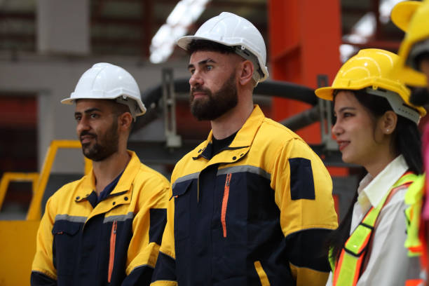 istock engineer team or worker team  with safety uniform standing at industry. 1775372058