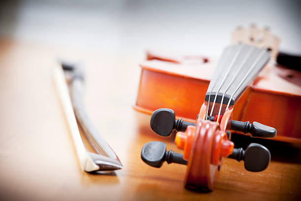 Close-up Violin laying on the wooden table stock photo