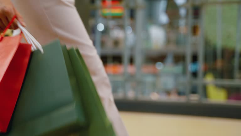 Asian woman carry shopping bags in a shopping mall.