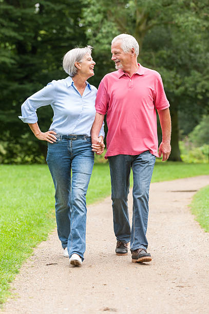 istock A senior couple holding hands walking in the park 177538005