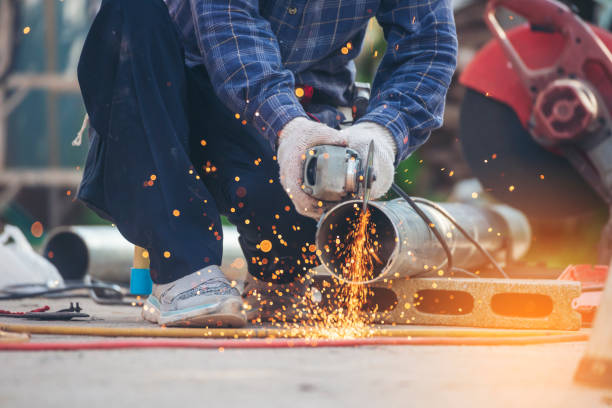 istock Construction Worker hands using Welding machinery iron metal sparking. Men hands wear protective glove Hot flame metal work cutting fire iron workshop. Locksmith use Welding machine cut metal process 1775381300