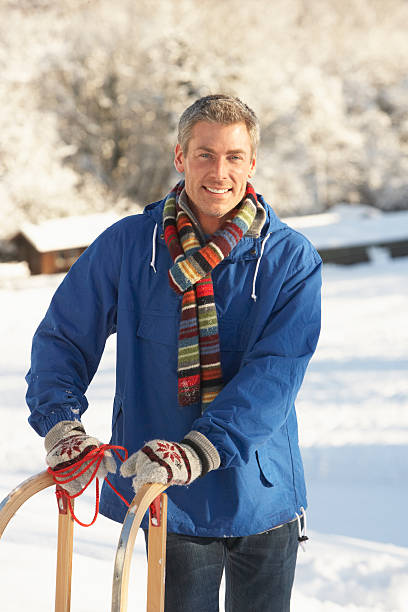 istock Middle Aged Man Standing In Snowy Landscape Holding Sledge 177538154