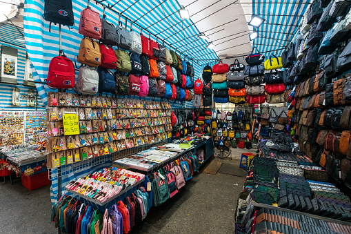 HongKong, China - November, 2019:  Bags, backpacks and clothing on street market (Ladie`s Market) in Hong Kong , Tung Choi Street