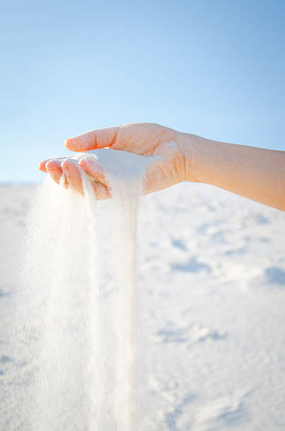 Female's hand strewing sand