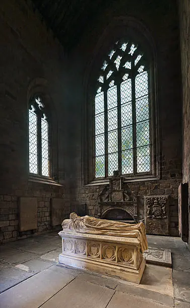 "Tomd and Gothic windows in Jedburgh Abbey ruins, Scottish Borders"