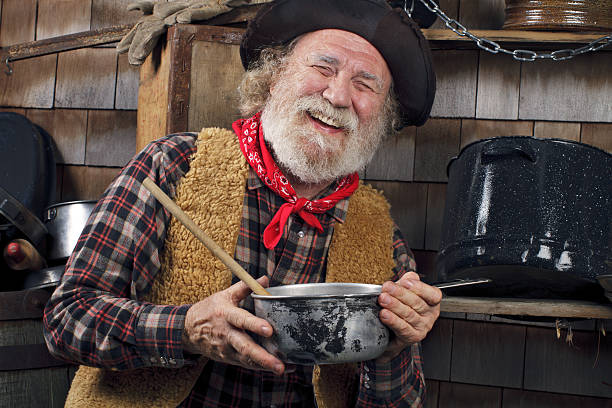 istock Laughing old cowboy cook holds a saucepan 177539287