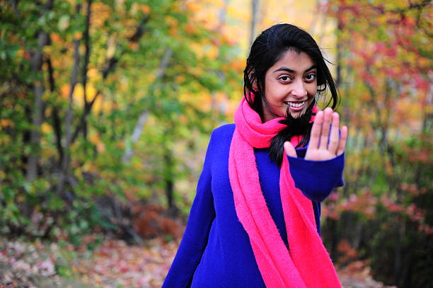 Indian Girl showing a hand to stop and giving an expression