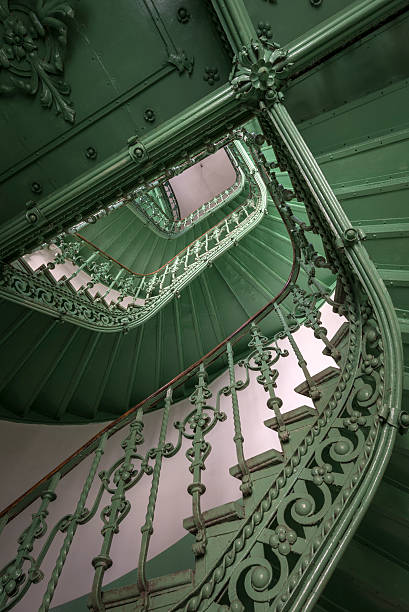 Vintage, green staircase in an old, dark abandoned building