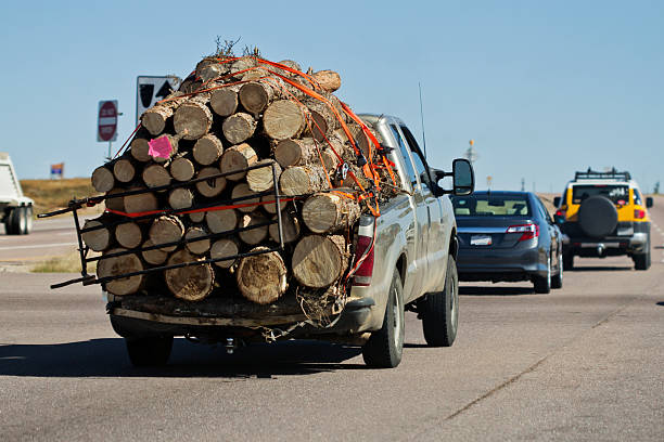 Truck Travelling On Roadway Heavily Overloaded By Wood Stock Photo -  Download Image Now - iStock