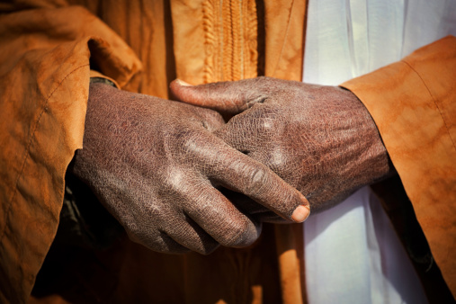 Hands of a nomad in the desert