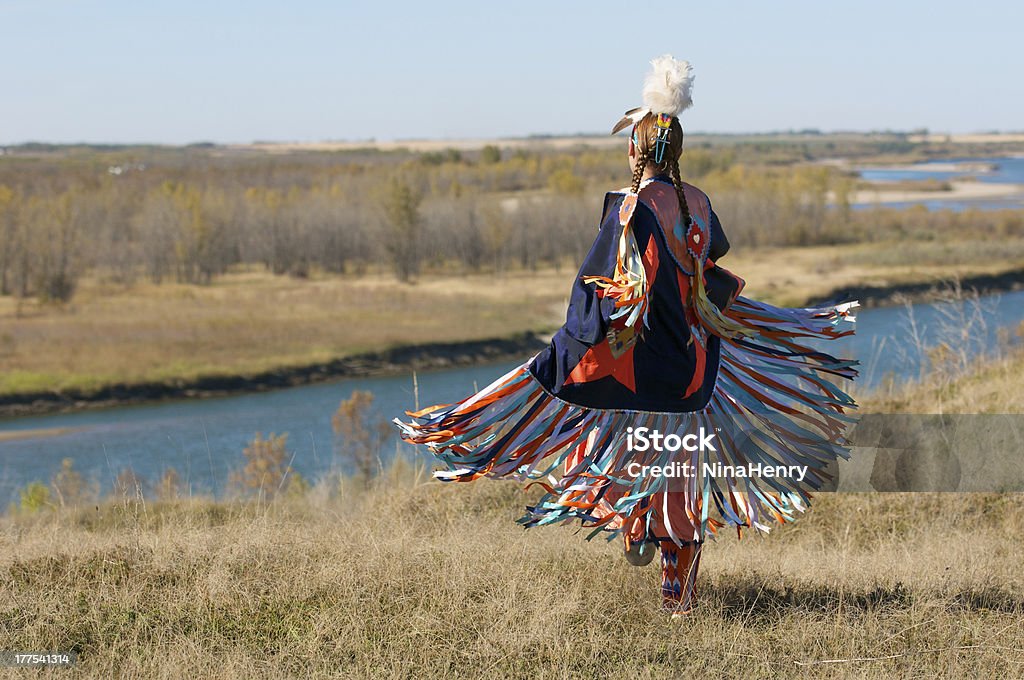 Women's Fancy Shawl Dance Movement First Nations Women performing a Fancy Shawl Dance in a grass field with a river background First Nations of Canada Stock Photo