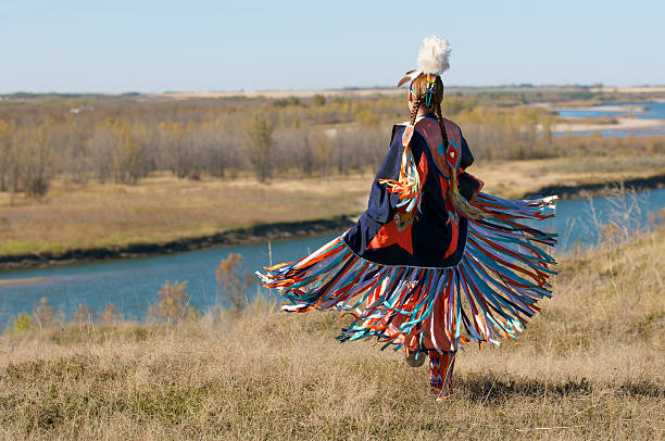 Women's Fancy Shawl Dance Movement First Nations Women performing a Fancy Shawl Dance in a grass field with a river background native american ethnicity stock pictures, royalty-free photos & images