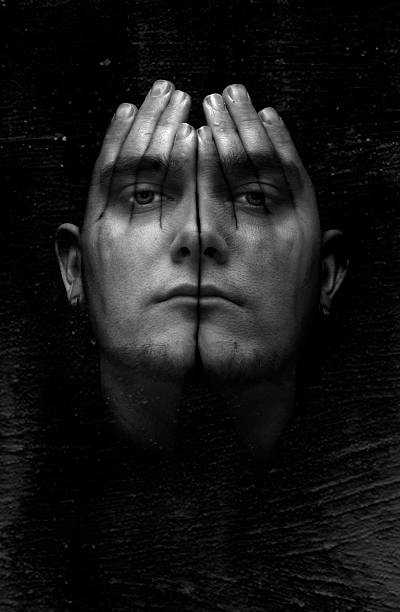 Insomnia A concept artwork of a male face covered with see-through hands on a textured black background. FL-photography stock pictures, royalty-free photos & images