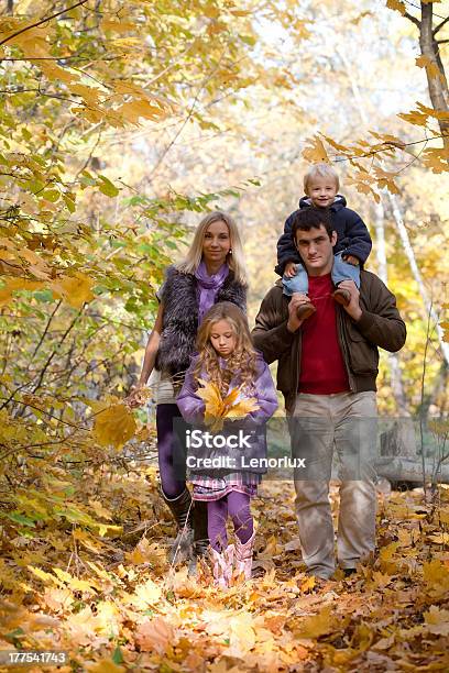 Family Enjoying Walk In Park Stock Photo - Download Image Now - 2-3 Years, 4-5 Years, 8-9 Years