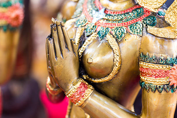 Female statue doing wai; South Eastern Asian gesture of respect.