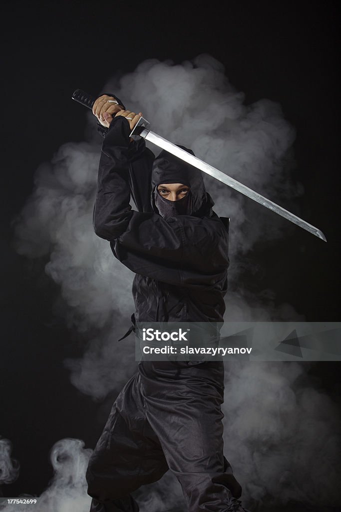 Ninja with sword at night in smoke Ninja with sword at night in smoke background Ninja Stock Photo