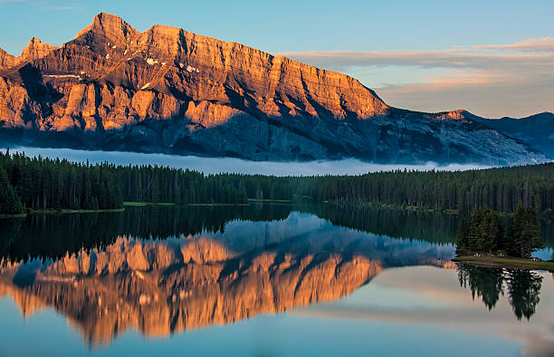 Orange Mountain Reflection in Lake Minnewanka stock photo
