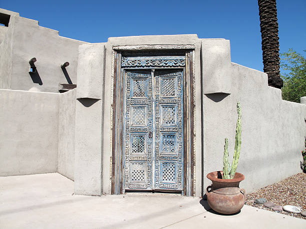 Beautiful revival style wooden door way with stucco wall