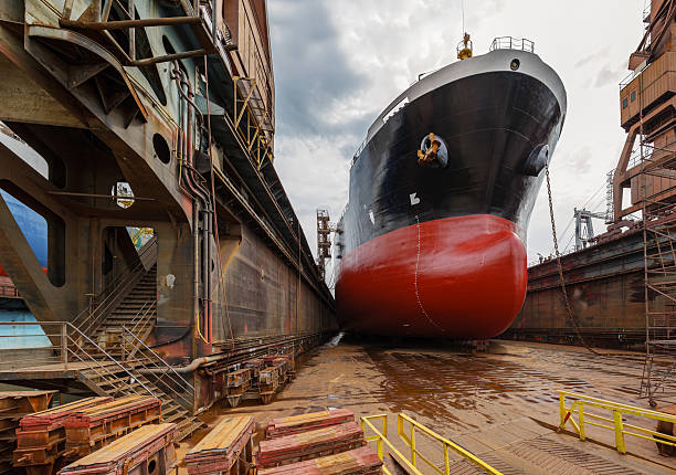 Tanker in dry dock "A large tanker ship is being renovated in shipyard Gdansk, Poland." dry dock stock pictures, royalty-free photos & images