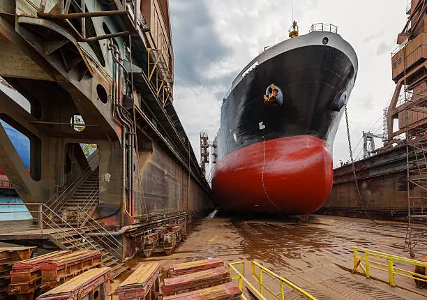 "A large tanker ship is being renovated in shipyard Gdansk, Poland."