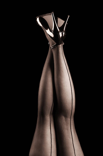 Glamour legs in stockings Sexy glamour legs wearing stockings and high heels. Black background-studio shot. pics for classic pin up poses stock pictures, royalty-free photos & images