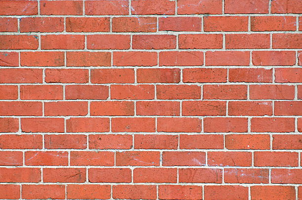 red brick wall with white mortar stock photo