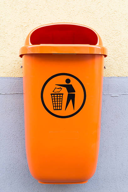 Recycle Bin Orange recycle bin on a wall. FL-photography stock pictures, royalty-free photos & images