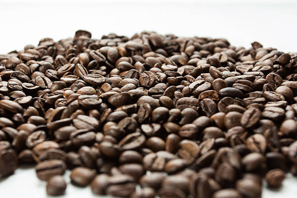 Coffeebeans A large amount of coffee beans.Photographed from front with white background and a short depth-of-field. FL-photography stock pictures, royalty-free photos & images