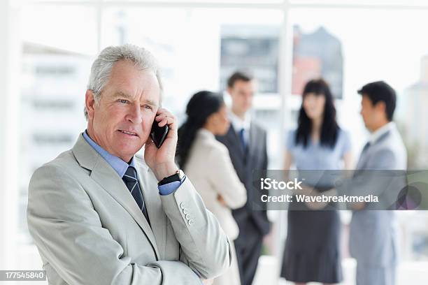 Serious And Mature Manager Talking On The Phone Stock Photo - Download Image Now - 20-29 Years, 30-39 Years, Adult