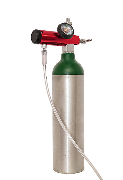 Portable Oxygen Cylinder For Medical Use Small portable oxygen cylinder for mobile emphysema patients, also used to treat COPD and asthma. Isolated on white with a clipping path. tracheotomy tubing stock pictures, royalty-free photos & images